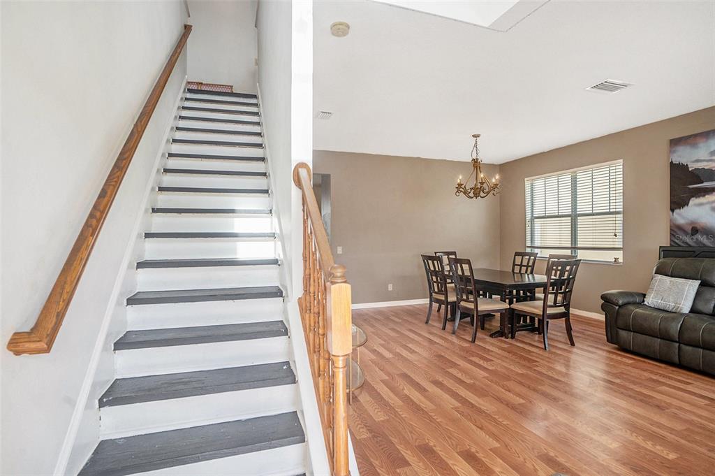 7641 Armonk Lane Wesley Chapel, FL 33545 - Photo 4 of 34 a view of a dining room with furniture and wooden floor