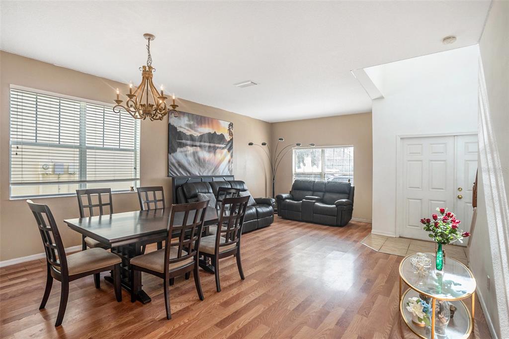 7641 Armonk Lane Wesley Chapel, FL 33545 - Photo 6 of 34 a view of a dining room with furniture window and wooden floor