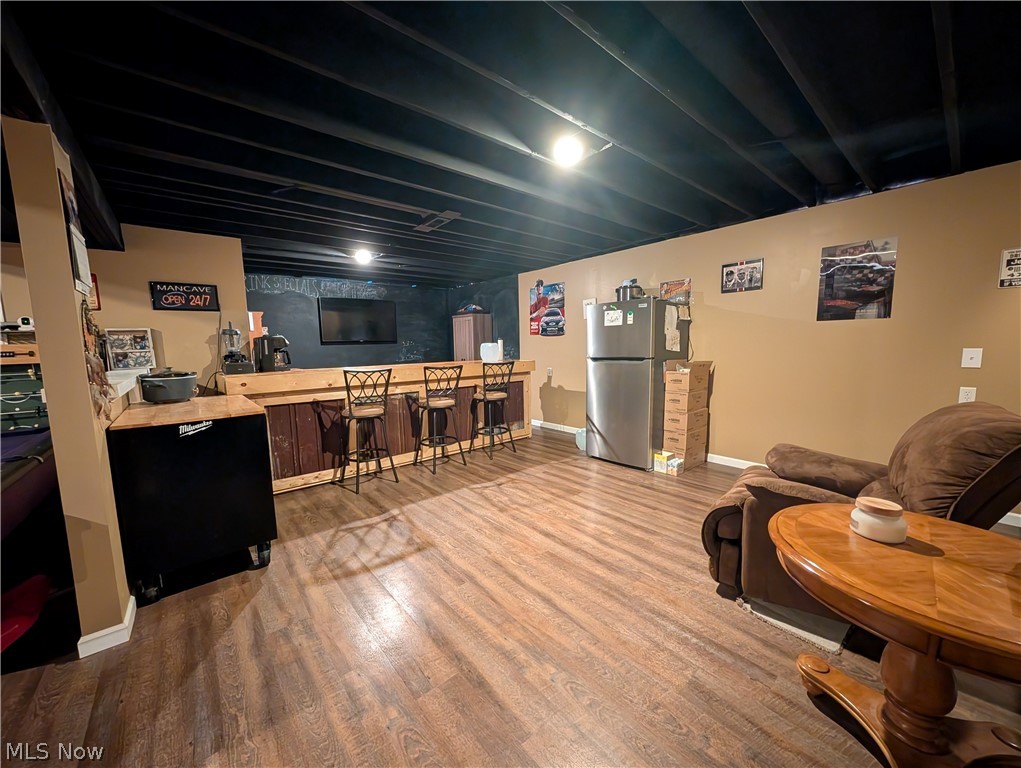 7360 Jones Road Nashport, OH 43830 - Photo 21 of 29 Living room with light wood-style flooring and bar area
