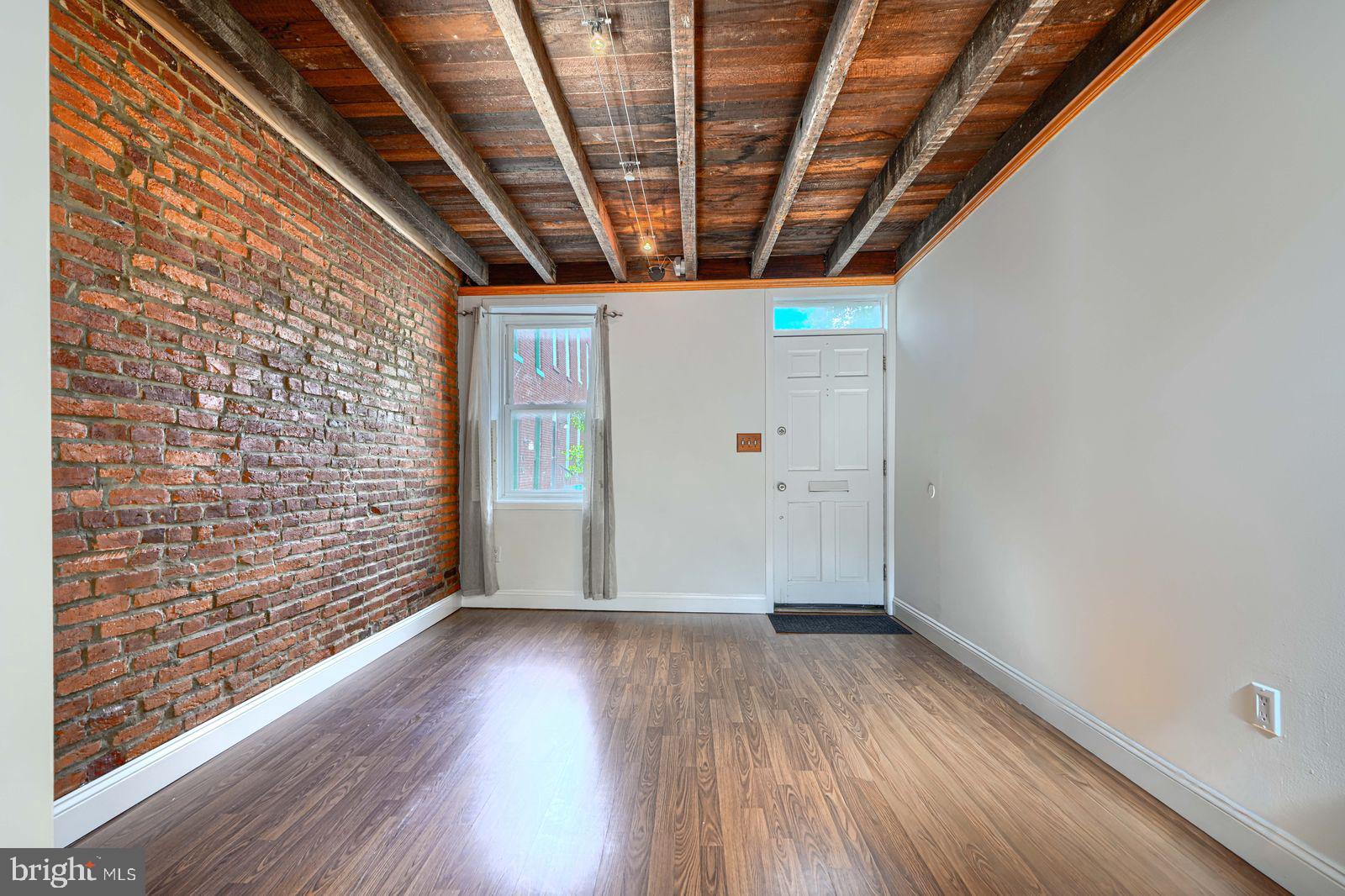 1026 Patapsco Street Baltimore, MD 21230 - Photo 4 of 24 a view of empty room with wooden floor