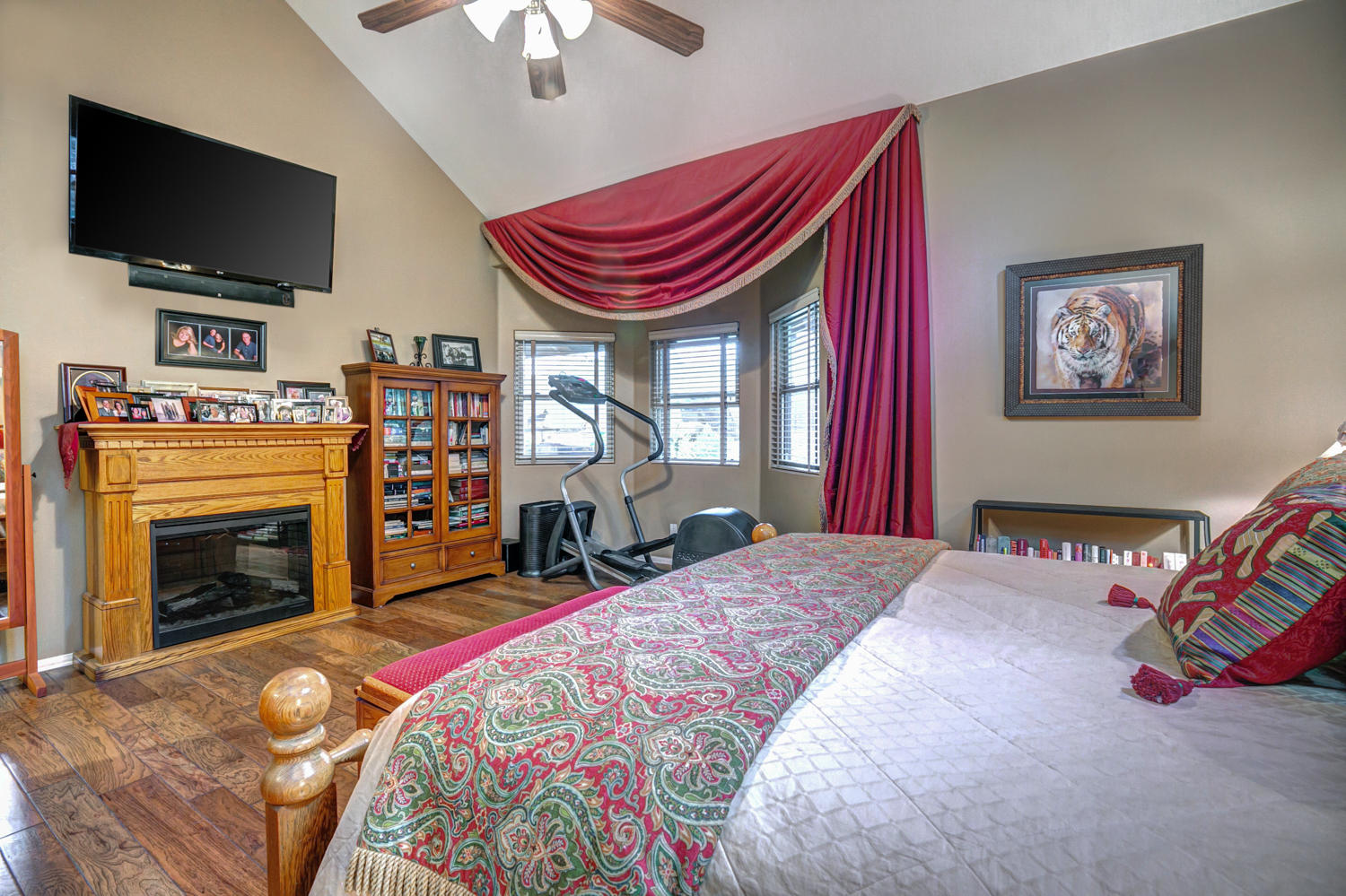 179 Baldwin Road Ojai, CA 93023 - Photo 17 of 39 a bedroom with a bed a flat screen tv and a chandelier