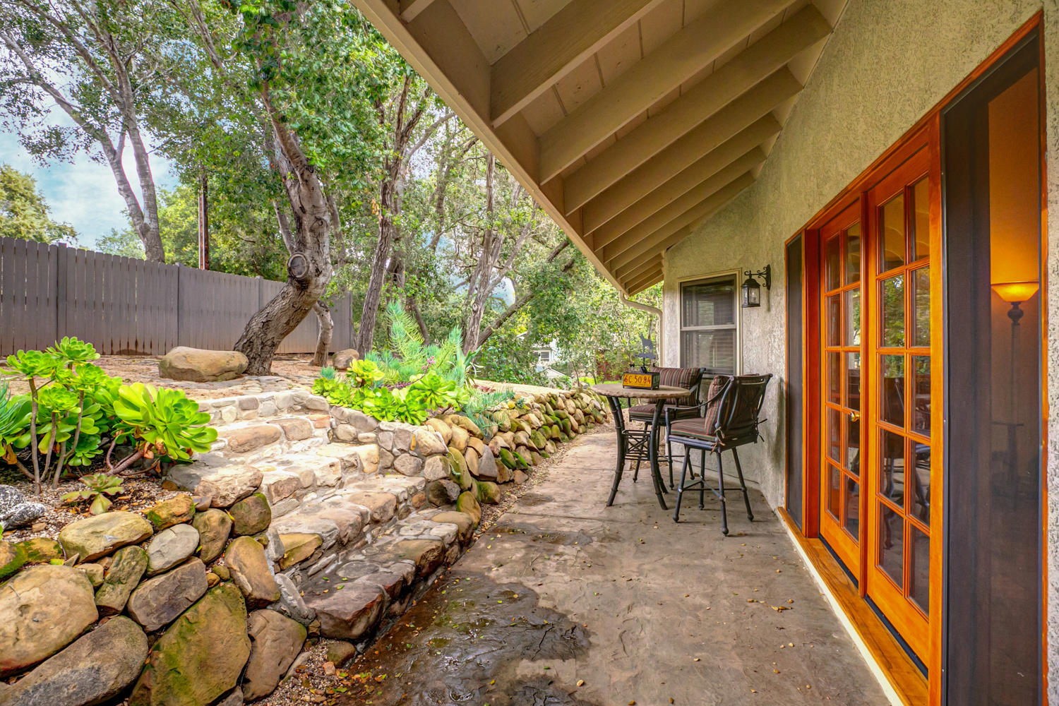 179 Baldwin Road Ojai, CA 93023 - Photo 31 of 39 a view of a patio with table and chairs potted plants and floor to ceiling window