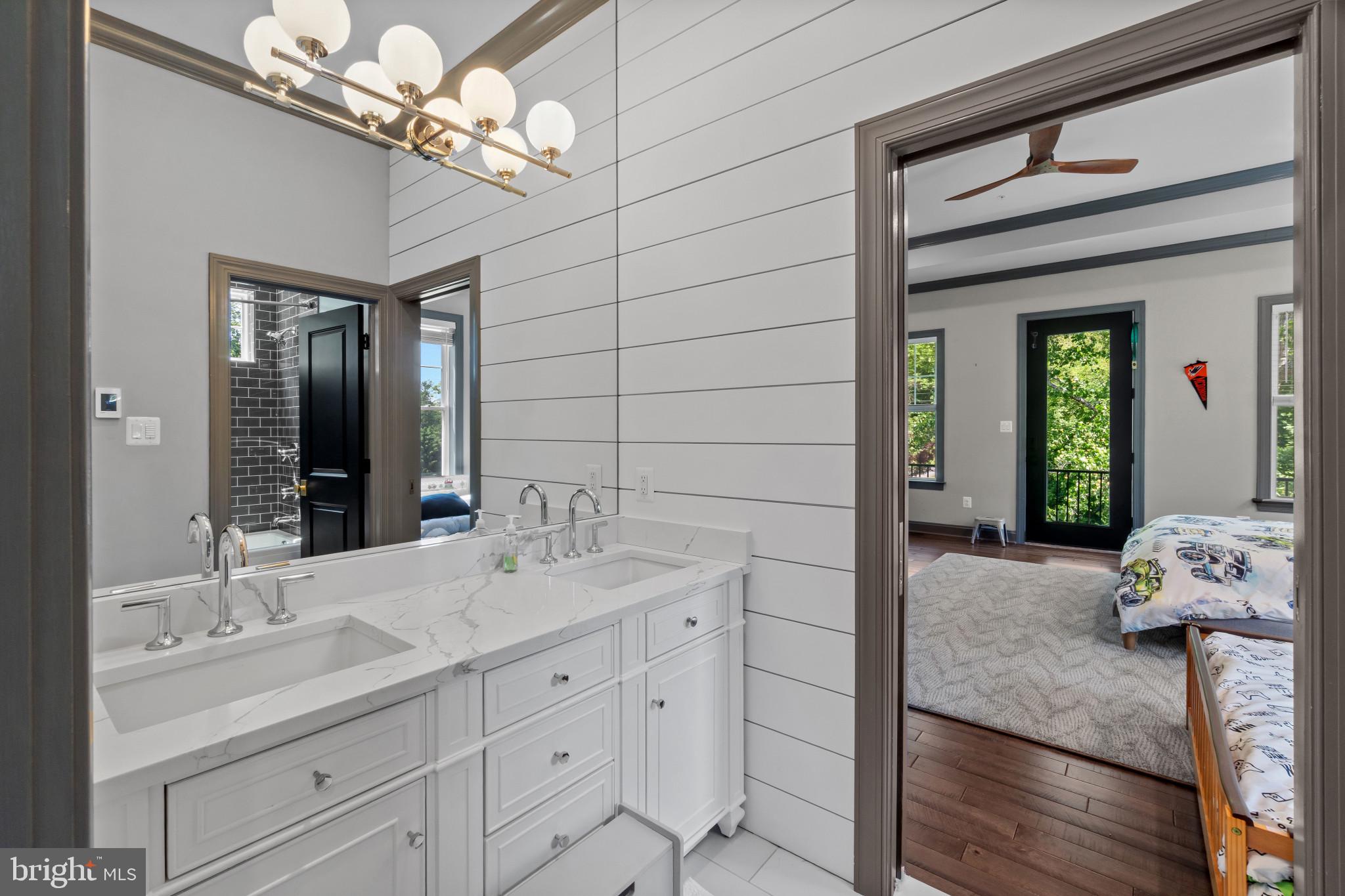 10907 Hollow Road Cockeysville, MD 21030 - Photo 23 of 57 a bathroom with a sink a potted plant and a mirror