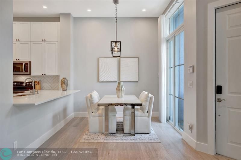 2870 Marina Circle Lighthouse Point, FL 33064 - Photo 11 of 37 a view of a kitchen area with furniture and wooden floor