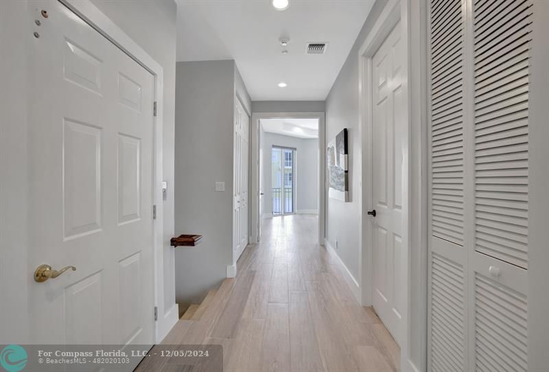2870 Marina Circle Lighthouse Point, FL 33064 - Photo 16 of 37 a view of a hallway with wooden floor