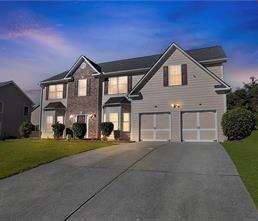 2580 Hamrick Road Douglasville, GA 30134 - Photo 1 of 1 a front view of a house with a yard and garage