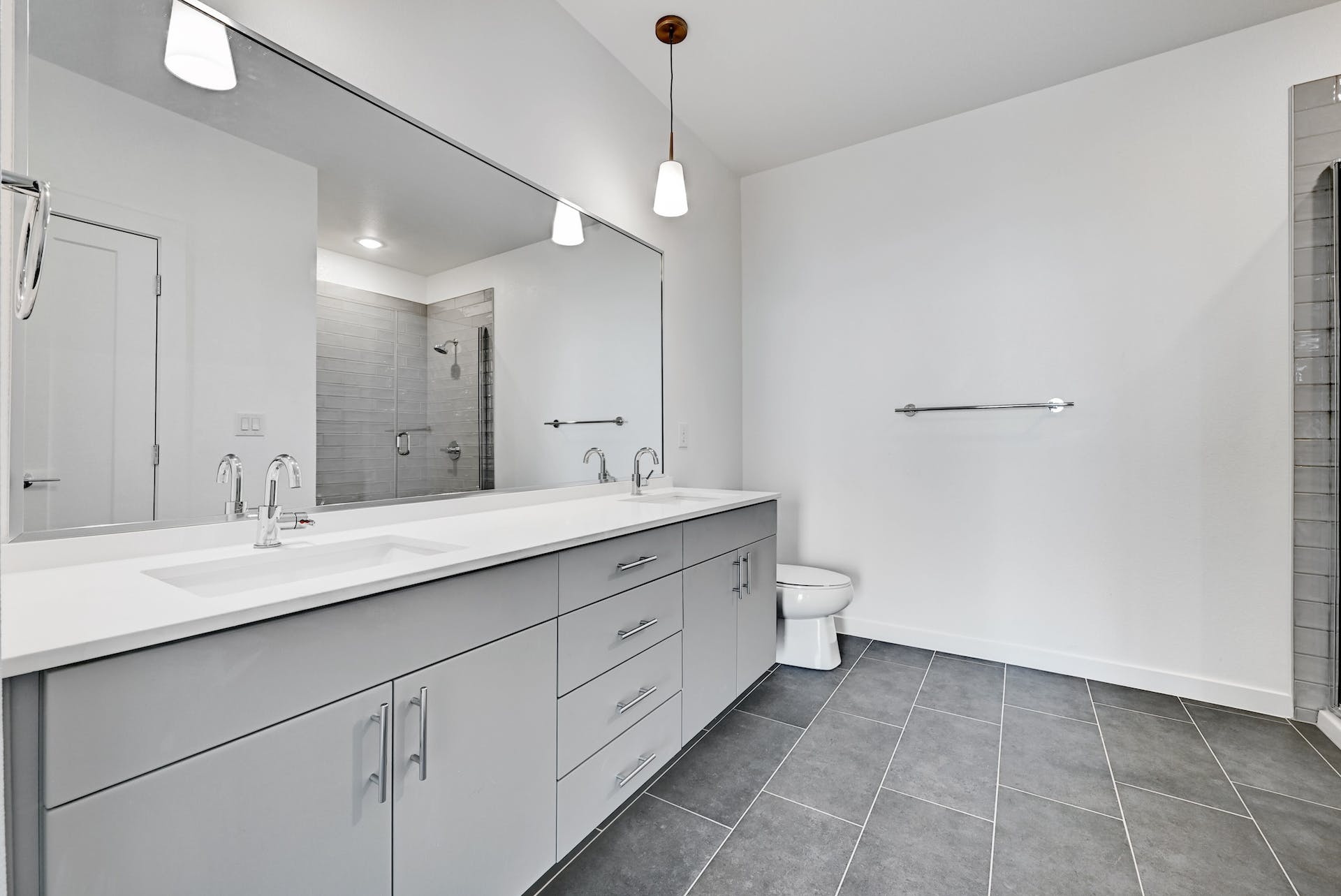 4801 Springdale Road, Unit 1301 Austin, TX 78723 - Photo 24 of 39 A sleek vanity with dual sinks, modern cabinetry, and ample mirror space anchors this contemporary bathroom.