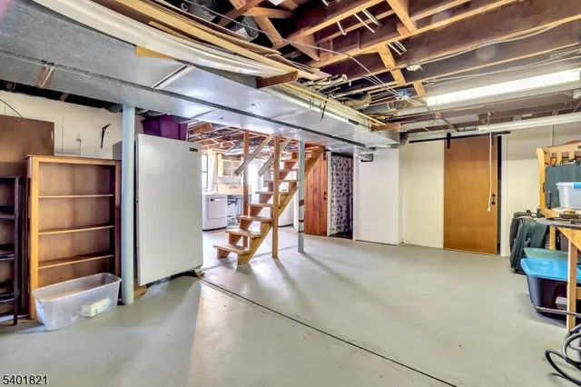 a view of water heater room with wooden floor