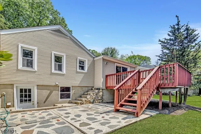 a front view of a house with wooden deck