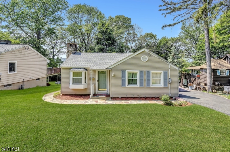 76 Hillside Road Sparta, NJ 07871 - Photo 2 of 18 a front view of a house with a garden and yard