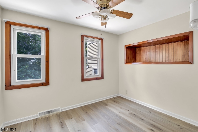 76 Hillside Road Sparta, NJ 07871 - Photo 9 of 18 a view of an empty room with window and wooden floor