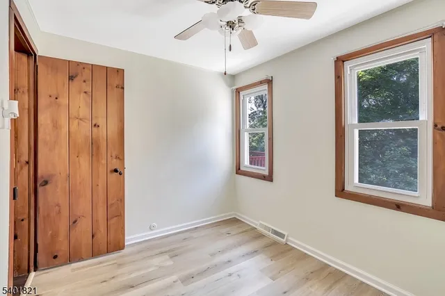 a view of an entryway with wooden floor and front door
