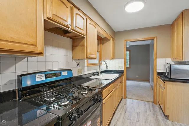 a kitchen with granite countertop a stove and a sink