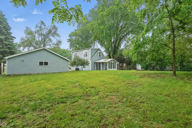 a view of a house with backyard porch and sitting area
