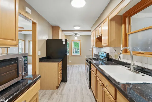 a kitchen with a sink stove and refrigerator
