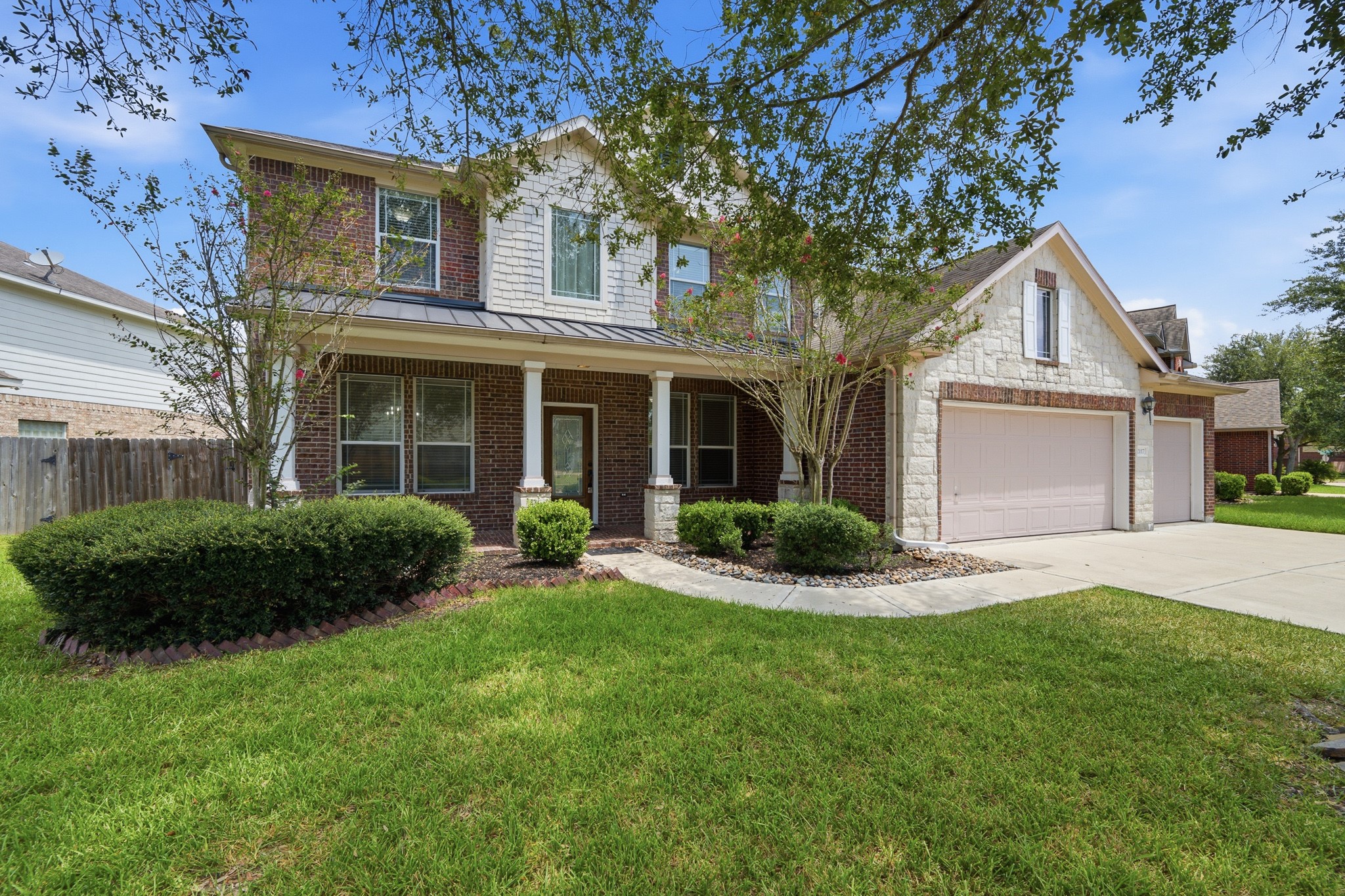 2117 Rushing Spring Drive Pearland, TX 77584 - Photo 2 of 42 Discover your dream residence with this charming brick and stone façade, offering a spacious layout and inviting curb appeal.