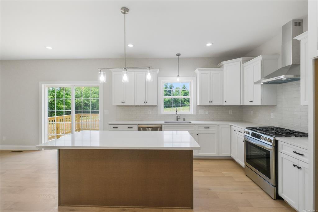 108 Browns Road Walden, NY 12586 - Photo 4 of 36 Kitchen with appliances with stainless steel finishes, sink, plenty of natural light, and wall chimney range hood