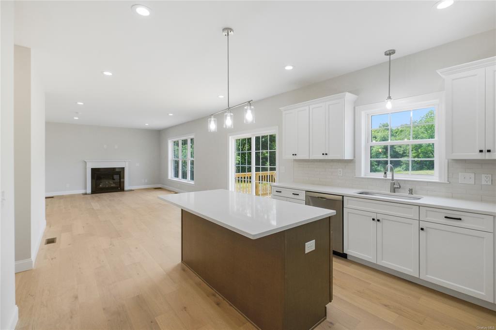 108 Browns Road Walden, NY 12586 - Photo 5 of 36 Kitchen featuring white cabinets, dishwasher, light hardwood / wood-style floors, and sink