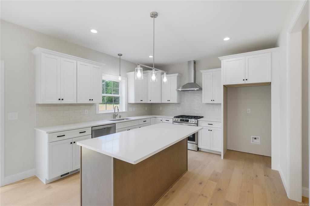 108 Browns Road Walden, NY 12586 - Photo 6 of 36 Plenty of Cabinets in this kitchen Range hood, oversized island, white cabinetry, and appliances with stainless steel finishes
