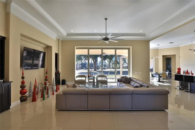 a living room with furniture and a chandelier