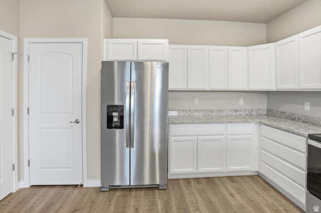 1838 West 300th Street South, Unit B Mapleton, UT 84664 - Photo 12 of 51 Kitchen featuring white shaker-style cabinetry, light-toned granite countertops, and wood-finish flooring