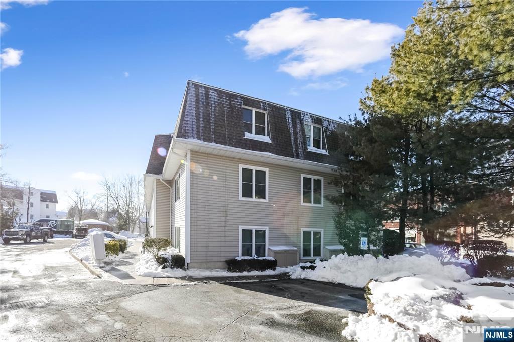 253 Park Avenue, Unit 304 Rutherford, NJ 07070 - Photo 5 of 23 a front view of a house with a yard