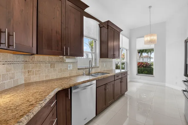 a kitchen with granite countertop a sink and a stove