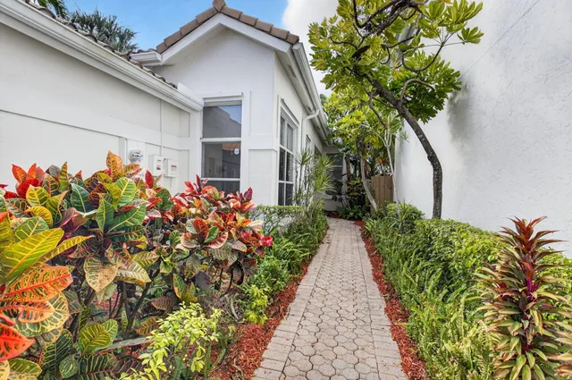 a front view of a house with a yard and flowers