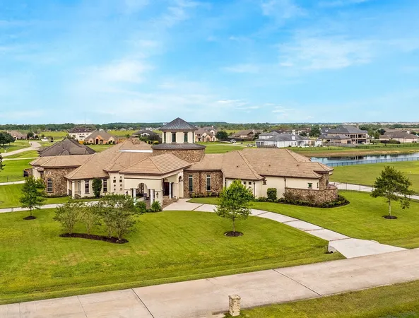 an aerial view of residential houses with outdoor space and swimming pool