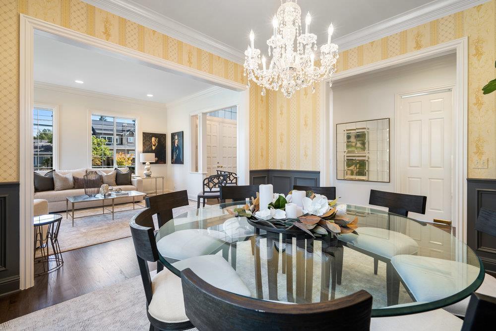 1700 Easton Drive Burlingame, CA 94010 - Photo 20 of 69 a dining room with furniture a chandelier and wooden floor