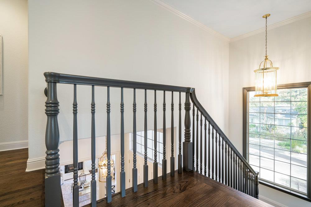 1700 Easton Drive Burlingame, CA 94010 - Photo 40 of 69 a view of a hallway with wooden floor and stairs