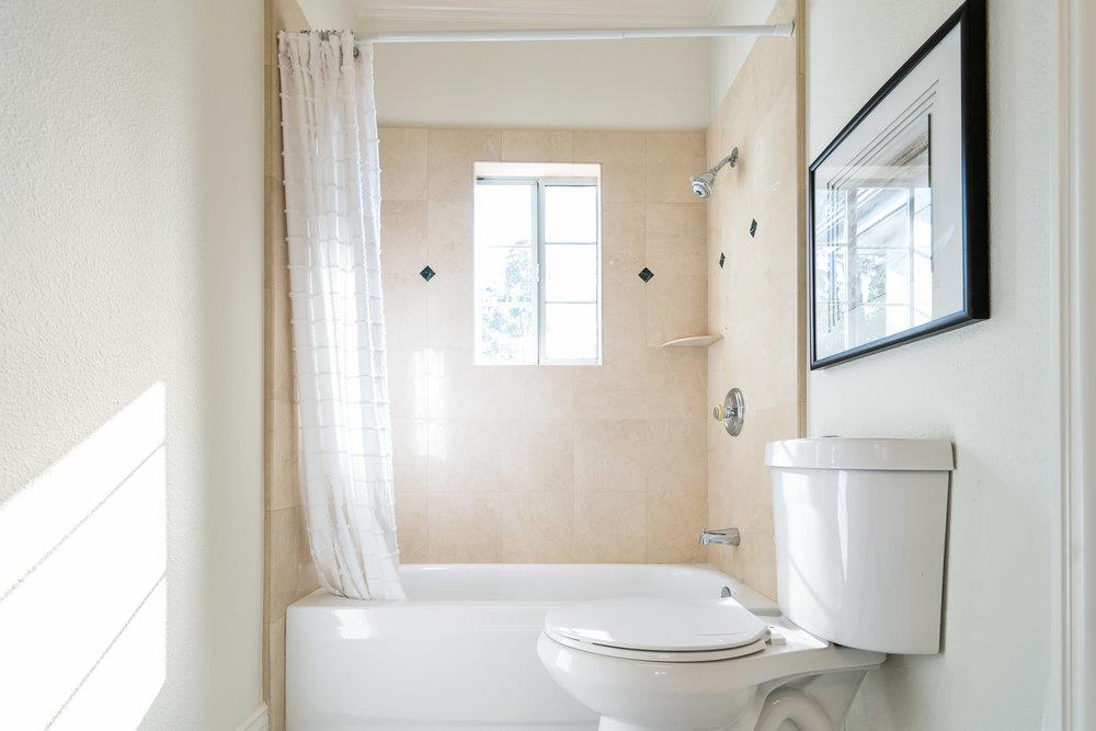 1700 Easton Drive Burlingame, CA 94010 - Photo 48 of 69 a white toilet sitting next to a bathroom sink and tub