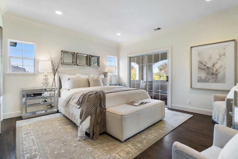 1700 Easton Drive Burlingame, CA 94010 - Photo 52 of 69 a spacious bedroom with a bed a couch and a window