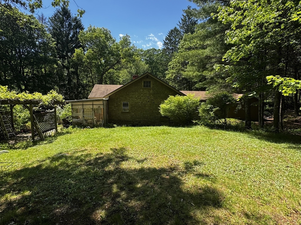 38 Rutland Street Carlisle, MA 01741 - Photo 6 of 18 a backyard of a house with lots of green space