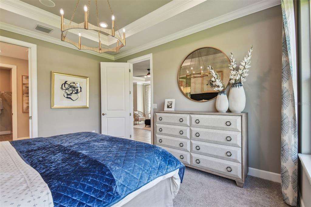 4257 Rosatti Road Wesley Chapel, FL 33543 - Photo 15 of 96 a bedroom with a bed a dresser and painting on the wall