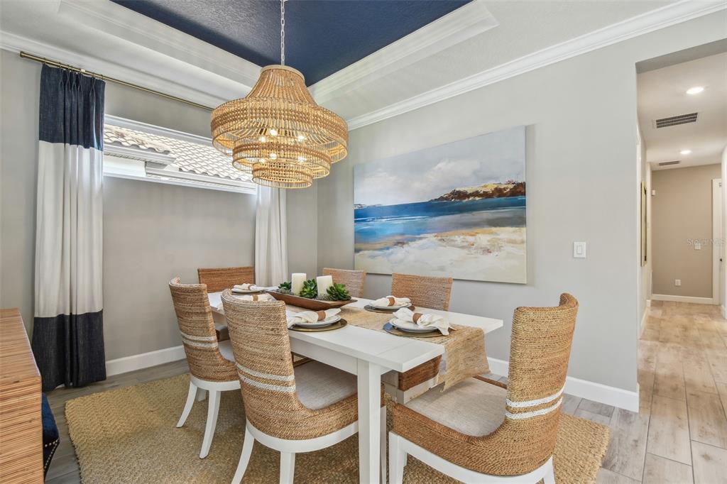 4257 Rosatti Road Wesley Chapel, FL 33543 - Photo 33 of 96 a view of a dining room with furniture a chandelier and wooden floor