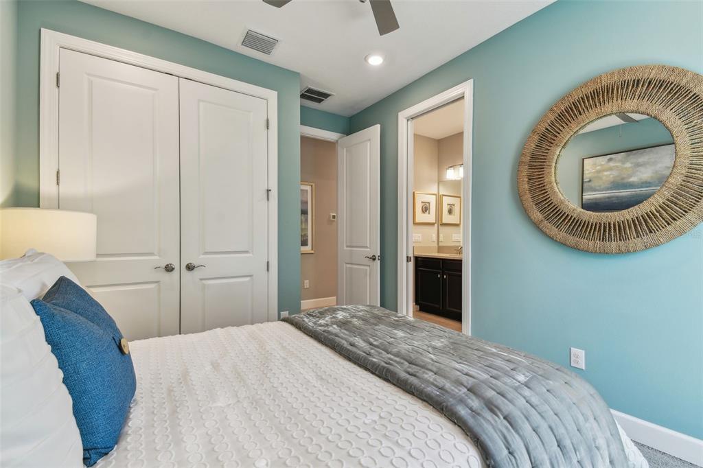 4257 Rosatti Road Wesley Chapel, FL 33543 - Photo 36 of 96 a bedroom with a bed and a mirror