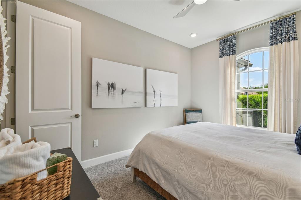 4257 Rosatti Road Wesley Chapel, FL 33543 - Photo 46 of 96 a bedroom with a bed painting on wall and a large window