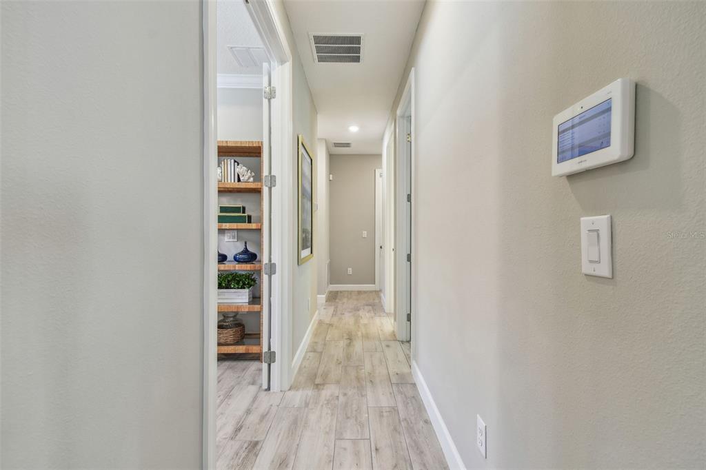 4257 Rosatti Road Wesley Chapel, FL 33543 - Photo 65 of 96 a view of a hallway with wooden floor and closet