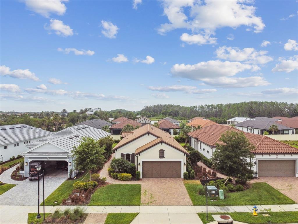 4257 Rosatti Road Wesley Chapel, FL 33543 - Photo 71 of 96 an aerial view of a house with a yard basket ball court and outdoor seating