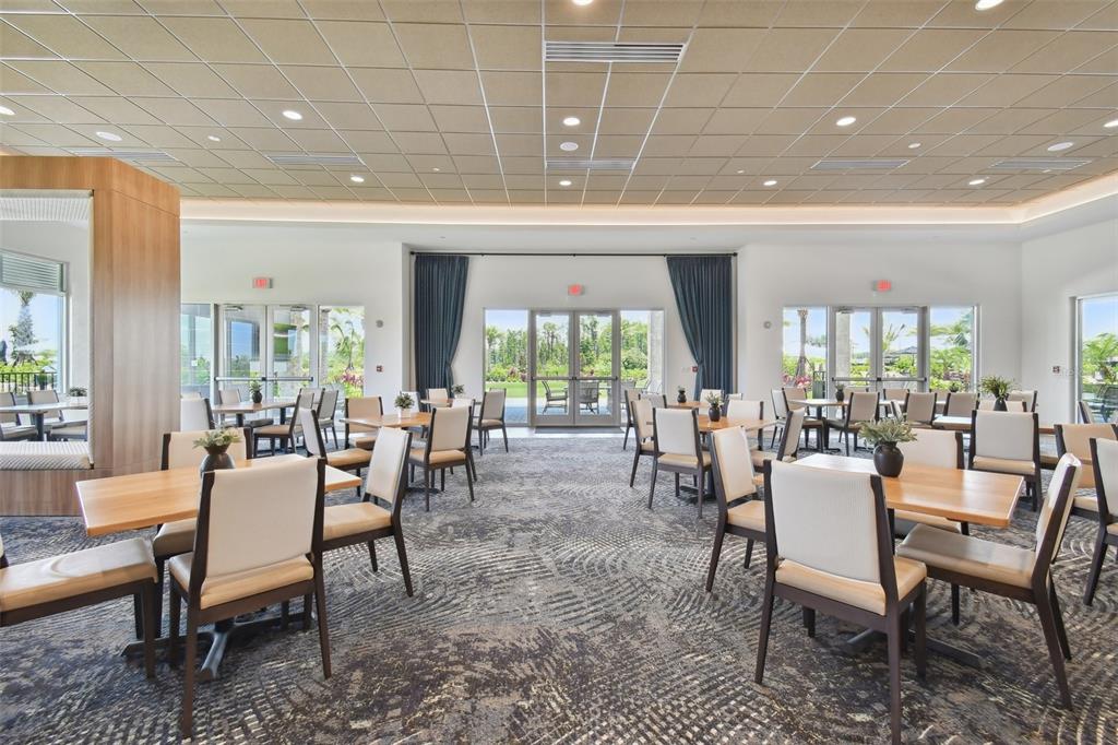 4257 Rosatti Road Wesley Chapel, FL 33543 - Photo 84 of 96 a dining room with furniture a rug and a chandelier