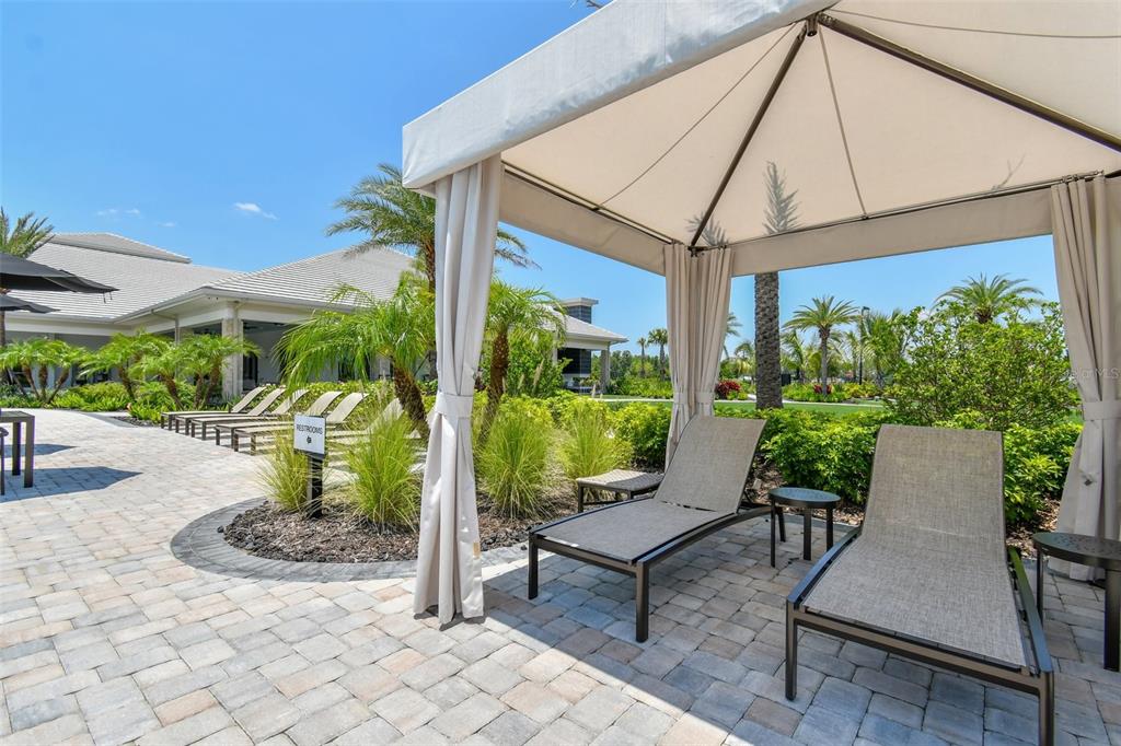4257 Rosatti Road Wesley Chapel, FL 33543 - Photo 92 of 96 a view of a patio with table and chairs potted plants and a palm tree