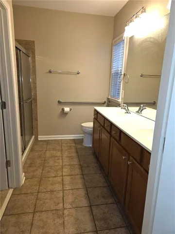 a bathroom with a sink a toilet and a mirror