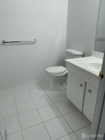 a white toilet sitting next to a white sink