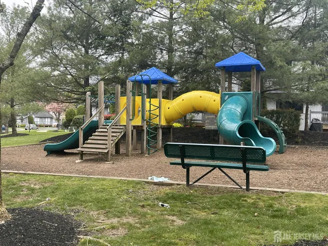 a swimming pool with outdoor seating and garden