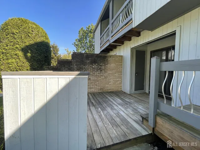 a view of balcony with wooden floor and fence