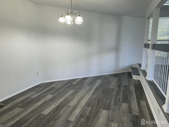 a view of wooden floor and windows in a room