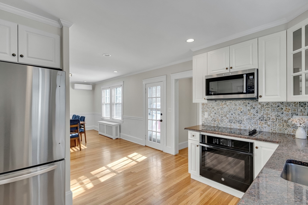 10 Dexter Road Lexington, MA 02420 - Photo 18 of 35 a kitchen with granite countertop a refrigerator stove and microwave