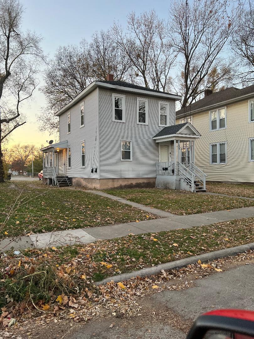 343 South Harrison Avenue, Unit 343 Kankakee, IL 60901 - Photo 1 of 5 a view of a house with a yard covered in the forest