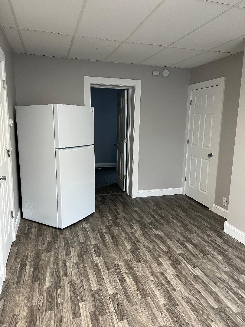 343 South Harrison Avenue, Unit 343 Kankakee, IL 60901 - Photo 4 of 5 a view of a refrigerator in kitchen and wooden floor